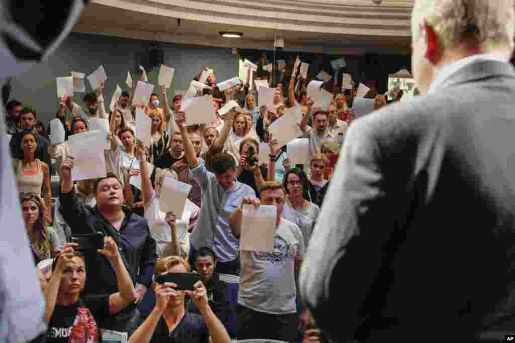 Theater staff show their resignation letters to Yuri Bondar, Belarusian Minister of Culture, in the Janka Kupala National Theater in Minsk after the theater's director, Pavel Latushko, was fired.
