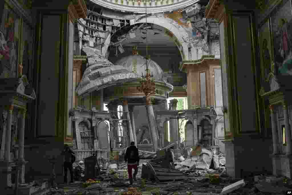 Church personnel inspect damages inside the Odesa Transfiguration Cathedral in Odesa, Ukraine, following Russian missile attacks.