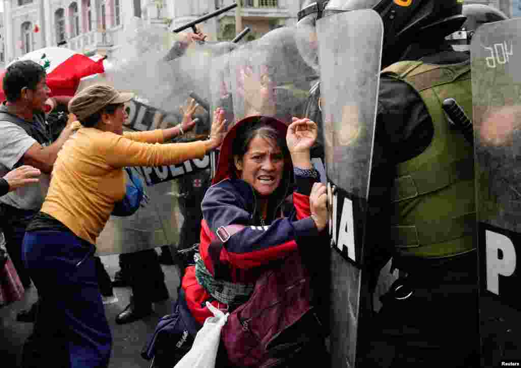 Anti-government demonstrators clash with police officers during a national protest to demand the resignation of Peruvian President Dina Boluarte, in Lima, Peru, July 29, 2023.