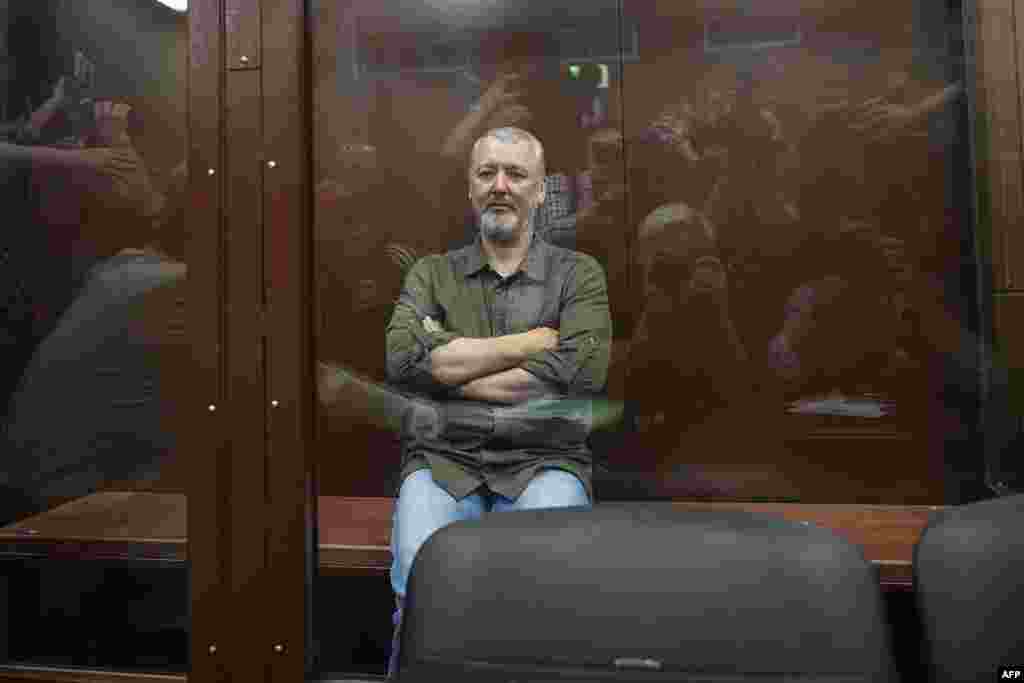 Igor Girkin (Strelkov), the former top military commander of the self-proclaimed Donetsk People's Republic and nationalist blogger, detained earlier Friday and accused of extremism, sits inside a glass defendants' cage during a hearing to consider a request on his pre-trial arrest in Moscow.