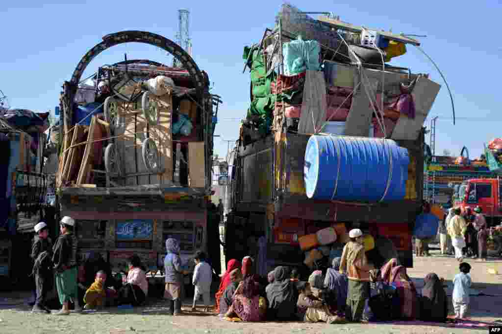 Afghan refugees sit by the trucks at a registration center upon their arrival from Pakistan, near the Afghanistan-Pakistan border in the Spin Boldak district of Kandahar province.