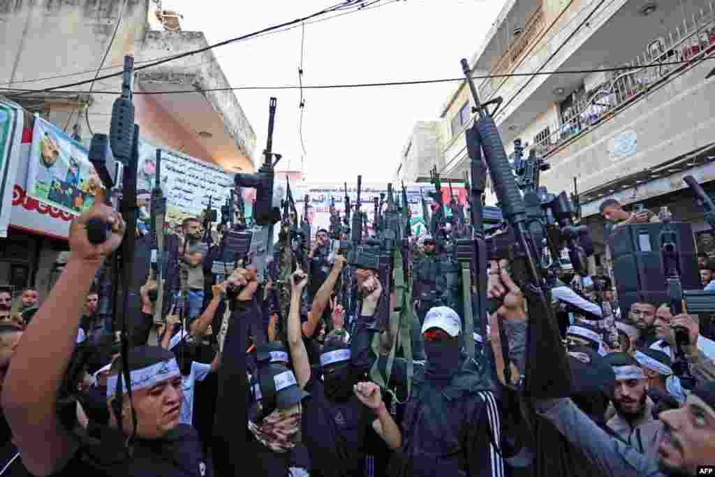 Palestinian militants from the Balata Brigade gather during a memorial rally in the refugee camp of Balata near the West Bank city of Nablus, marking the death anniversary of Mohammed Abu Asab, who was killed by Israeli security forces.