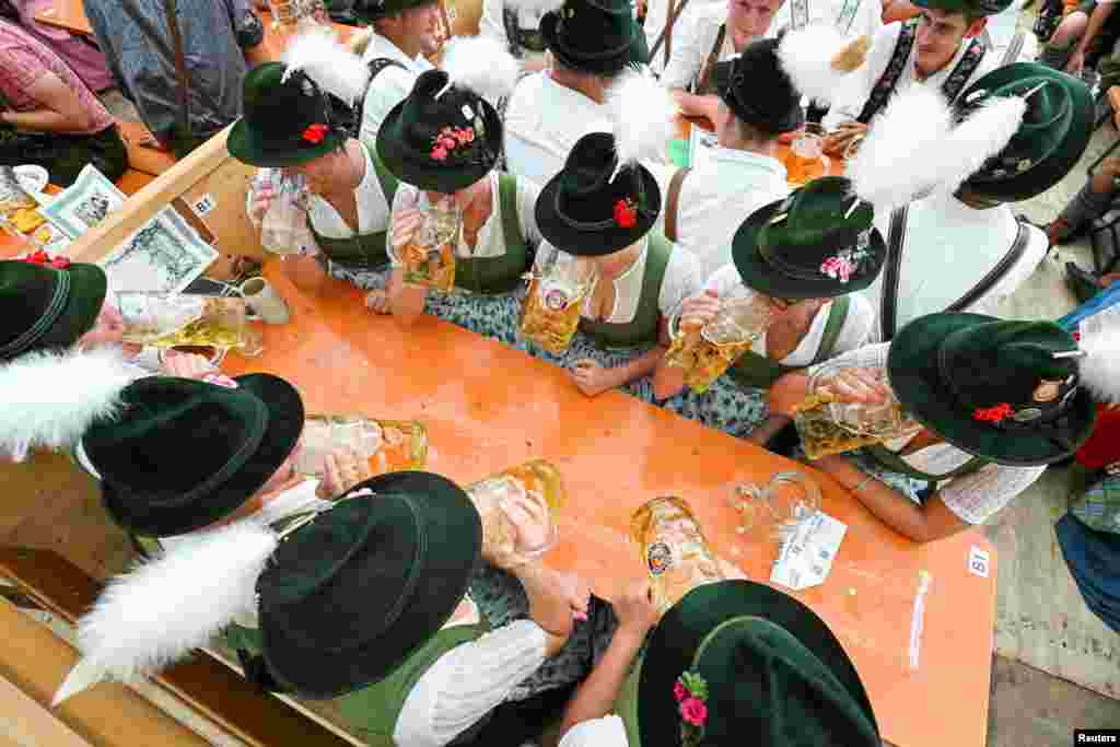 Visitors celebrate the world&#39;s largest beer festival, the 188th Oktoberfest, in Munich, Germany.