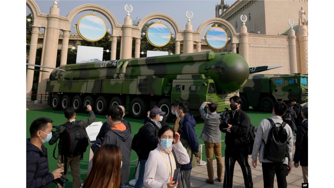 FILE - Visitors tour past military vehicles carrying the Dong Feng 41 and DF-17 ballistic missiles at the Beijing Exhibition Hall in Beijing on Oct. 12, 2022. (AP Photo/Andy Wong)