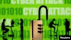 3D printed models of people working on computers and padlock are seen in front of a displayed CYBER ATTACK and binary code in this picture illustration taken, February 1, 2022. (REUTERS/Dado Ruvic/Illustration)