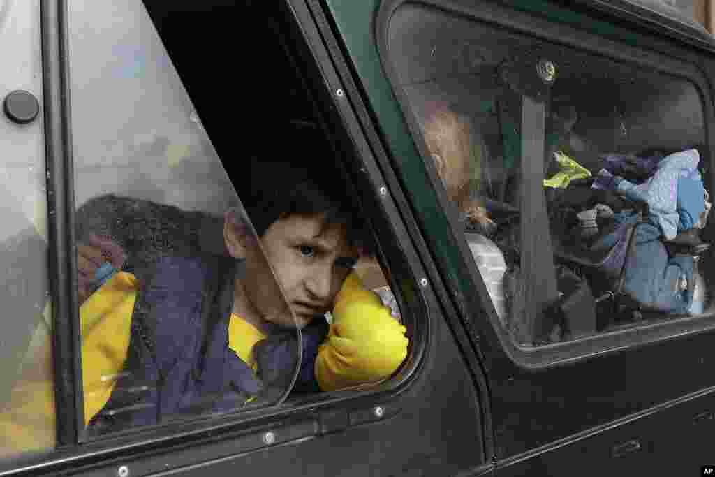 An ethnic Armenian boy from Nagorno-Karabakh looks on from a car upon arrival in Armenia's Goris, the town in Syunik region, Armenia. Thousands of Armenians have streamed out of Nagorno-Karabakh after the Azerbaijani military reclaimed full control of the breakaway region last week.