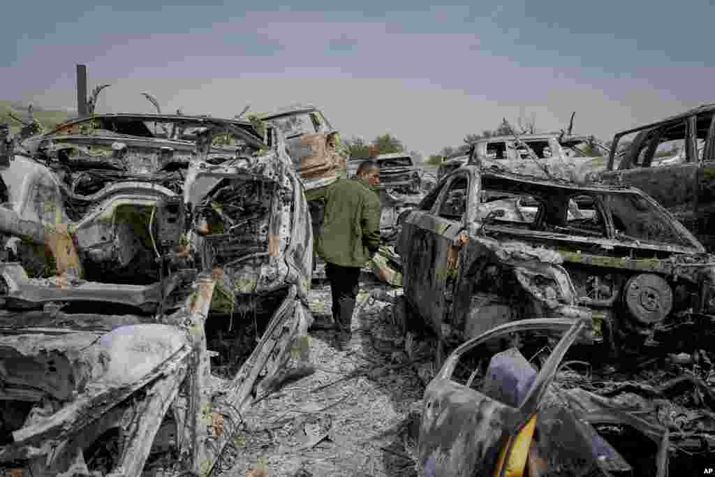 A Palestinian man walks between scorched cars in a scrapyard, in the town of Hawara, near the West Bank city of Nablus. Scores of Israeli settlers went on a violent rampage in the northern West Bank, setting cars and homes on fire after two settlers were killed by a Palestinian gunman. 