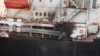 FILE - This photo shows the U.S.-owned Genco Picardy that was attacked Jan. 17, 2024, with a drone launched by Houthis in the Gulf of Aden. The International Rescue Committee is now diverting aid shipments away from the Red Sea. (Indian navy via AP)