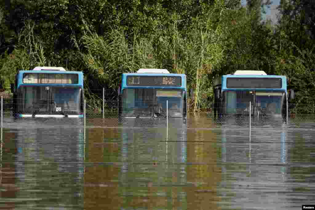 Buses are submerged in floodwater as the Pinios River overflows following torrential rains in the area, in Larissa, Greece.