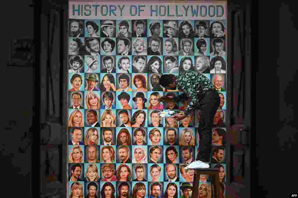 Artist Jagjot Singh Rubal puts final touches on a painting of portraits of Hollywood actors and musicians ahead of the 95th Oscars awards, at his workshop in Amritsar, India.