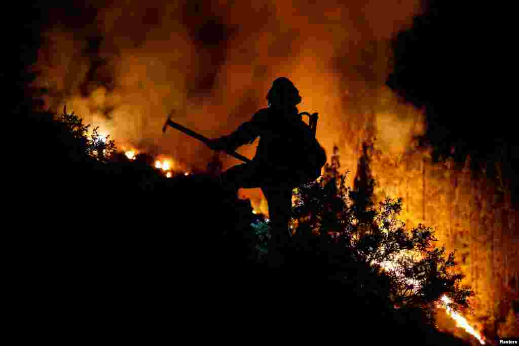EIRIF forest firefighters work to extinguish the forest fire in Arafo on the island of Tenerife, Canary Islands, Spain, Aug. 16, 2023.