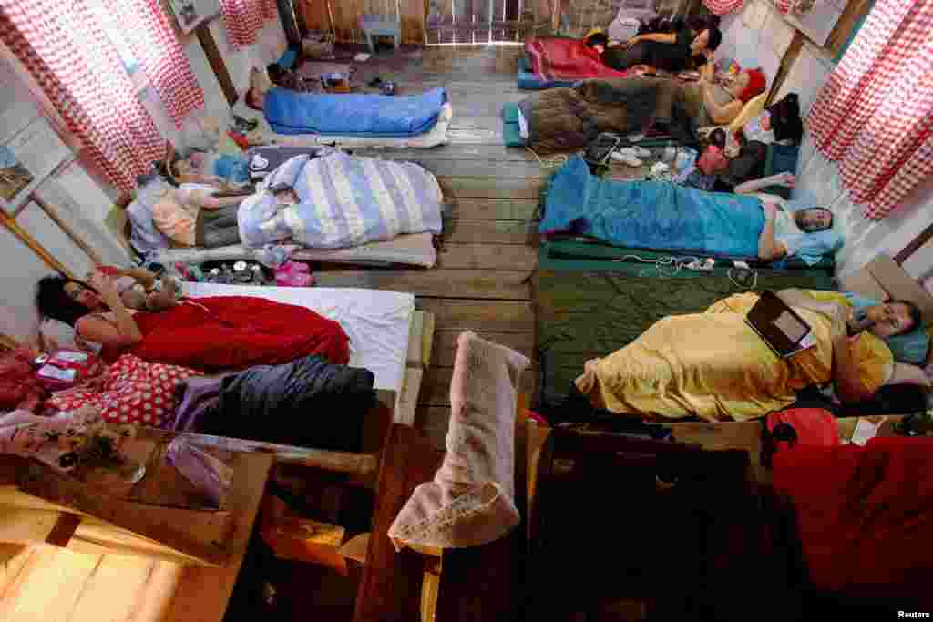 Participants lay inside a hut, as they participate in a satirical contest to mock a popular myth that labels Montenegrins as lazy people, in the village of Brezna, Pluzine, Montenegro, Sept. 6, 2023.