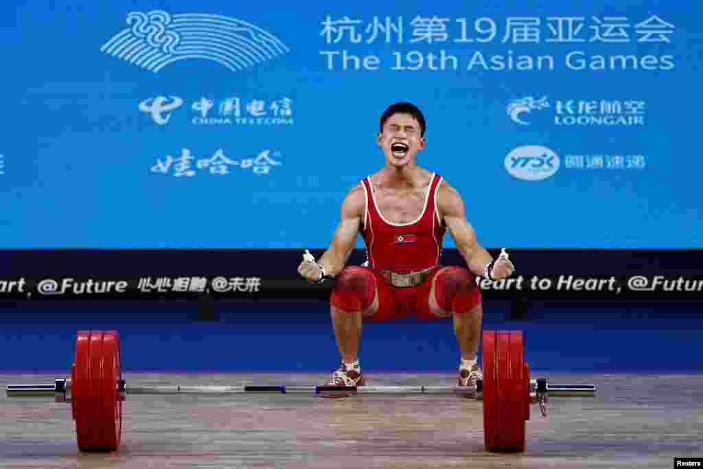 North Korea&#39;s Ri Wonju reacts at the 67Kg weightlifting Group A at the 19th Asian Games in Hangzhou, China.