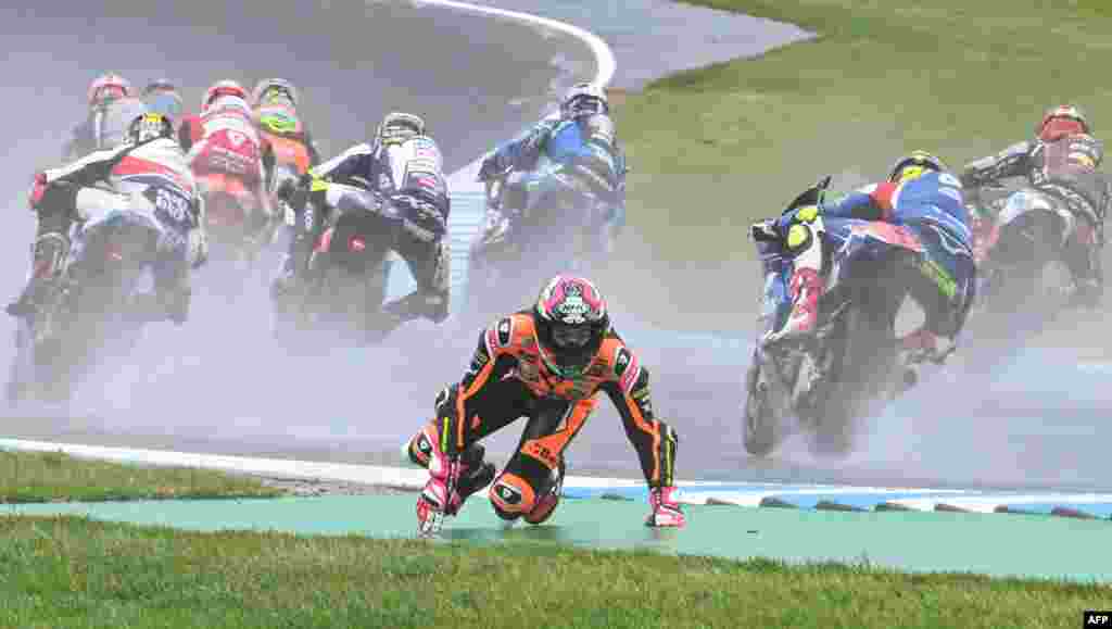 Beta Tools Speed Up's Spanish rider Alonso Lopez crashes out in the early stages of the Moto2 race at the MotoGP Australian Grand Prix in Phillip Island.