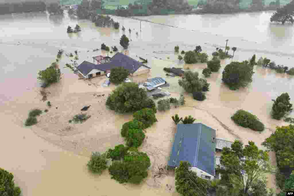 An aerial photo shows flooding caused by Cyclone Gabrielle in Awatoto, near the city of Napier. New Zealand declared a national state of emergency as Cyclone Gabrielle swept away roads, inundated homes and left more than 100,000 people without power. 