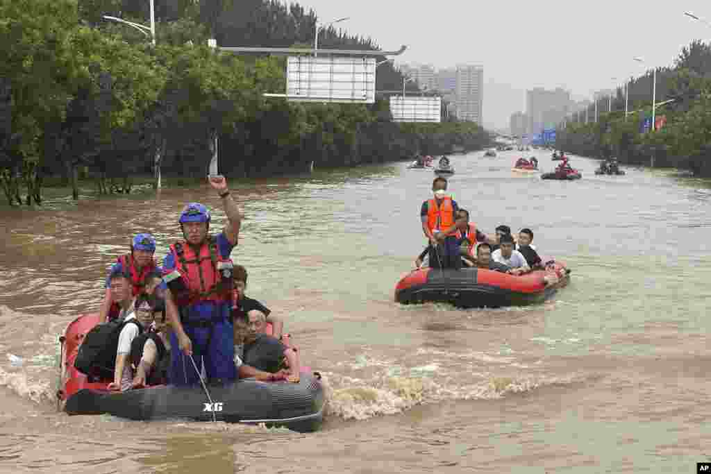 Residents are evacuated in rubber boats through flood waters in Zhuozhou in northern China's Hebei province, south of Beijing.
