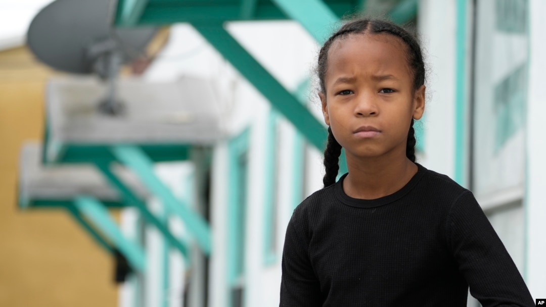 Ezekiel West, 10, stands for a portrait outside his home in Los Angeles on Sunday, Jan. 15, 2023. (AP Photo/Damian Dovarganes)