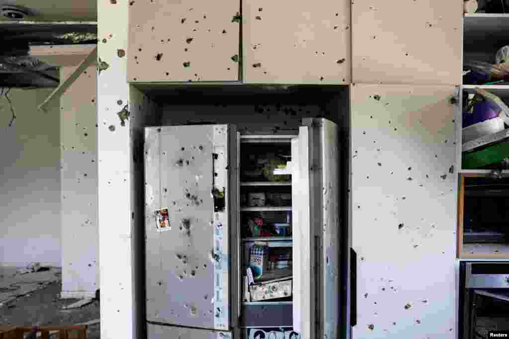 Bullet holes are seen on the cabinets and a refrigerator in the kitchen of a private home, following a deadly infiltration by Hamas gunmen from the Gaza Strip, in Kibbutz Kissufim in southern Israel, Oct. 21, 2023.