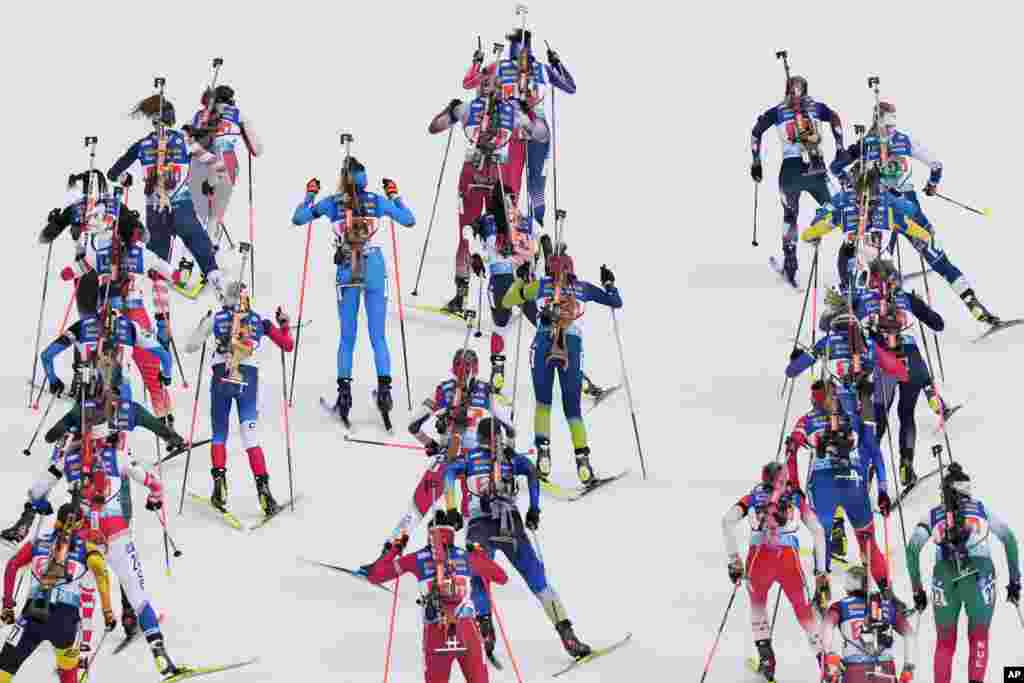 Contestants ski at the start of the Single Mixed Relay event at the Biathlon World Championships in Oberhof, Germany.