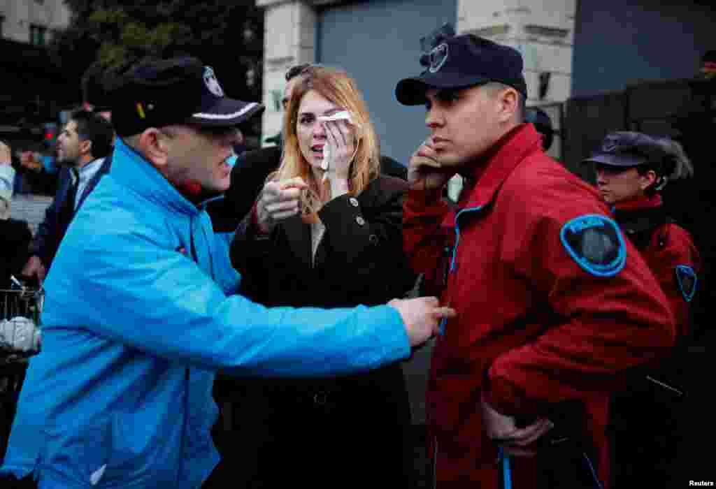 Lilia Lemoine, a candidate for Argentina's lower house of Congress, with the Libertad Avanza coalition, covers her eye after an alleged attack by protesters, outside the Buenos Aires City Legislature, in Buenos Aires, Sept. 4, 2023. Protesters were demonstrating against an event organized by Victoria Villarruel, running mate of presidential candidate Javier Milei of La Libertad Avanza coalition, to honor the victims of armed leftist groups during the 1970s.