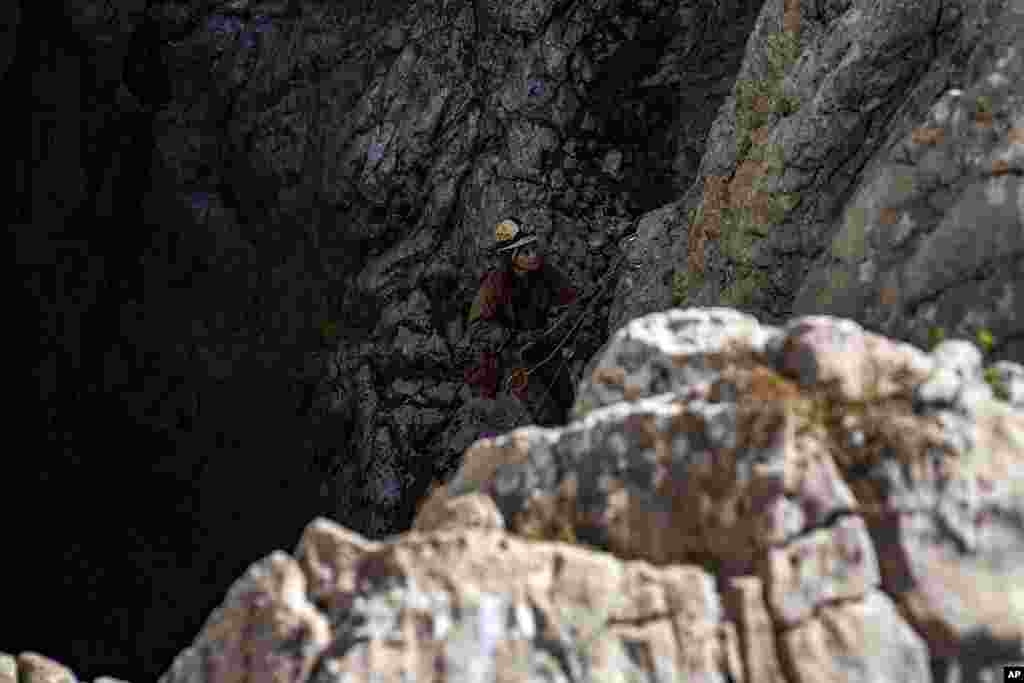 A European Cave Rescue Association member descends into the Morca cave near Anamur, southern Turkey, as experts work to save an ill American speleologist trapped at a depth of more than 1,000 meters (3,280 feet).