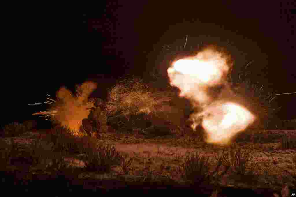 A Ukrainian soldier fires during night training in the Donetsk region.