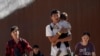 FILE - Migrants walk after crossing the U.S.-Mexico border near Jacumba, California, Oct. 24, 2023. China has resumed cooperating with the U.S. to repatriate Chinese migrants illegally stranded in the U.S., The Associated Press reported Thursday.   