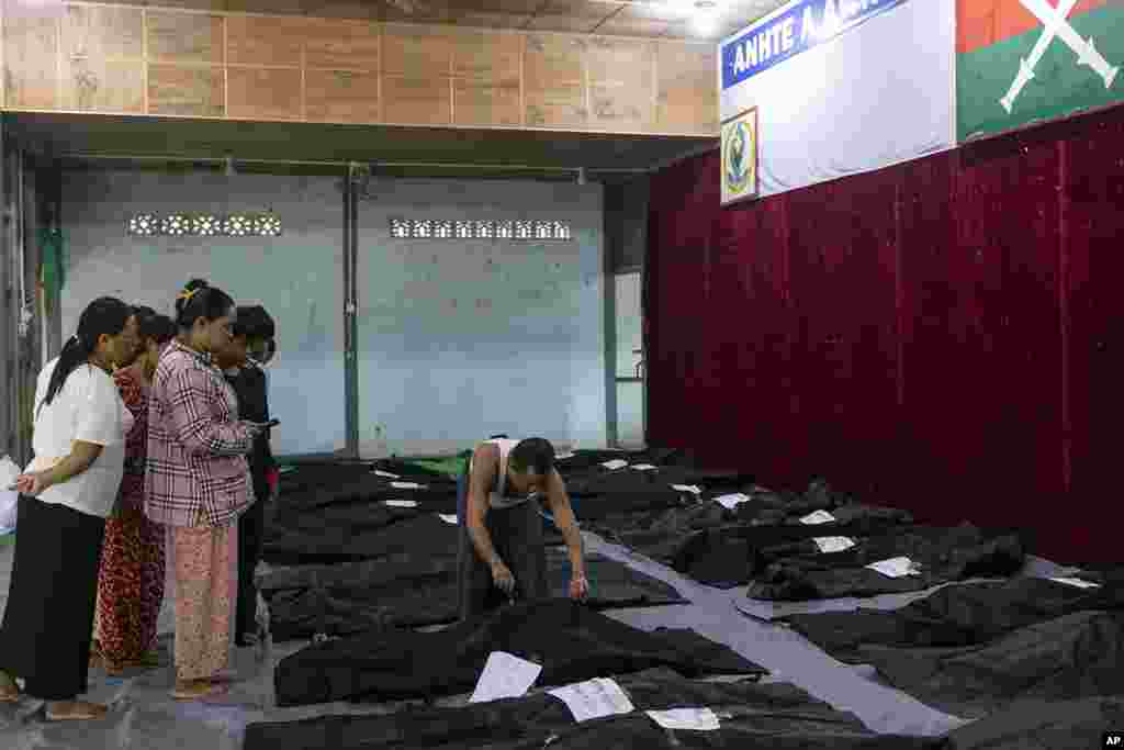 Family members check the bodies of relatives before being buried at a hospital in the town of Laiza, Myanmar. Myanmar’s military is accused of launching an airstrike on a camp for displaced persons in the northern state of Kachin that killed about 30 people, including about a dozen children. 