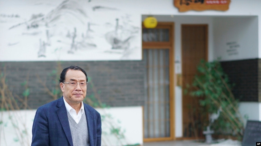 FILE - Virologist Zhang Yongzhen, the first scientist to publish a sequence of the COVID-19 virus, walks down a street in Shanghai, Dec. 13, 2020. Zhang was staging a sit-in protest after authorities locked him out of his lab. 