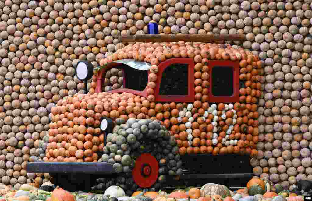 A fire engine made of pumpkins is seen at a pumpkin exhibition in the garden of Ludwigsburg Castle in Ludwigsburg, southern Germany. The pumpkin exhibition is themed "Fire" and lasts until Dec. 3, 2023.