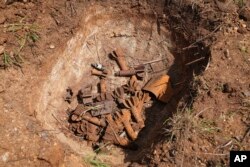Remnants of cluster munitions are seen at a clearance site in Ayii, Eastern Equatoria state, in South Sudan Thursday, May 11, 2023. (AP Photo/Sam Mednick)