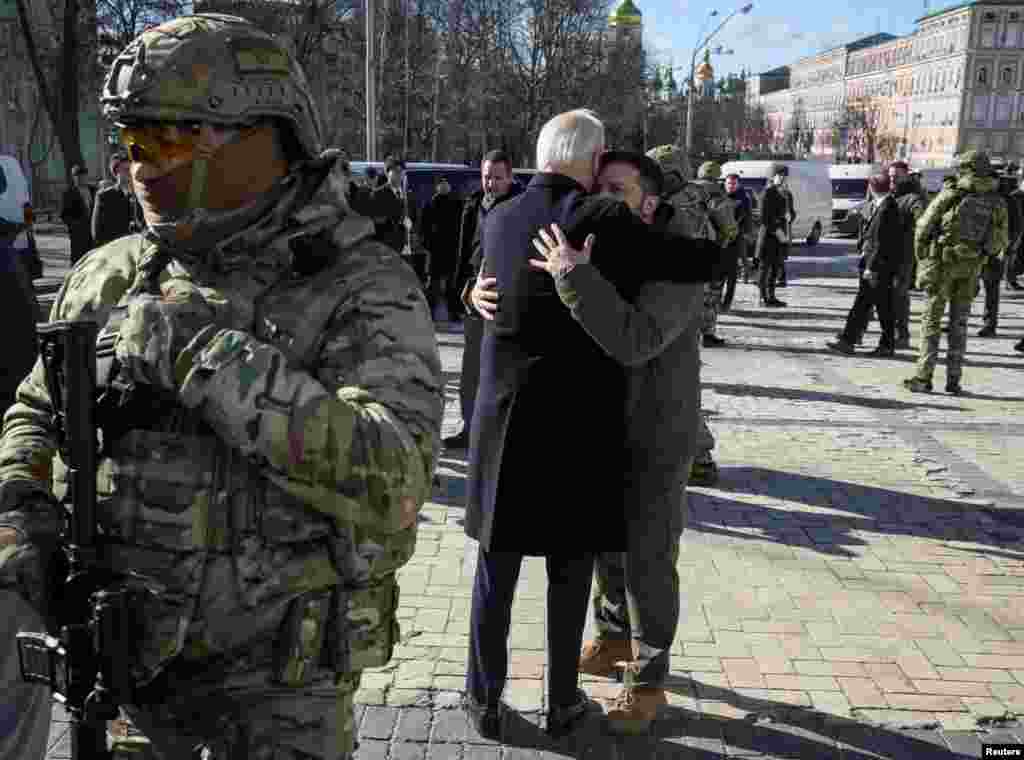 U.S. President Joe Biden and Ukraine's President Volodymyr Zelenskiy embrace after their visit to the Wall of Remembrance to pay tribute to killed Ukrainian soldiers, in Kyiv.