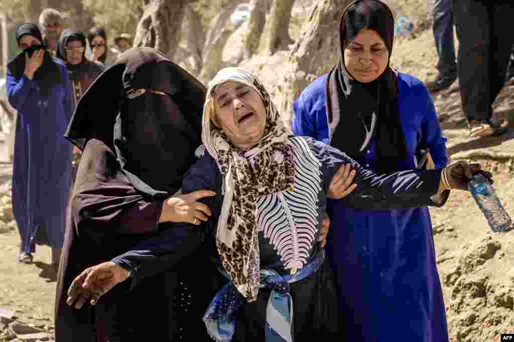 A woman reacts to the death of relatives in an earthquake in the mountain village of Tafeghaghte, southwest of Marrakesh, Morocco. Moroccans mourned the victims of a devastating earthquake that killed more than 2,000 people as the first foreign rescuers flew to help search the rubble of flattened villages. 