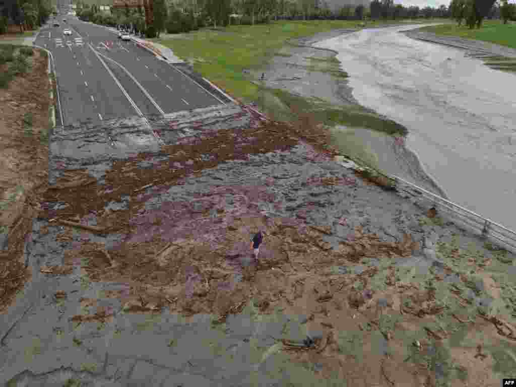 A man surveys debris following heavy rains from Tropical Storm Hilary, at Thurderbird Country Club in Rancho Mirage, California.