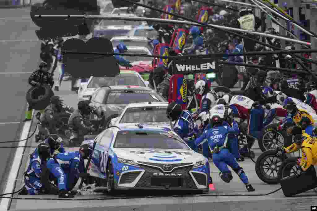 Christopher Bell (20) makes a pit stop during a NASCAR Cup Series auto race at Auto Club Speedway in Fontana, California, Feb. 26, 2023.