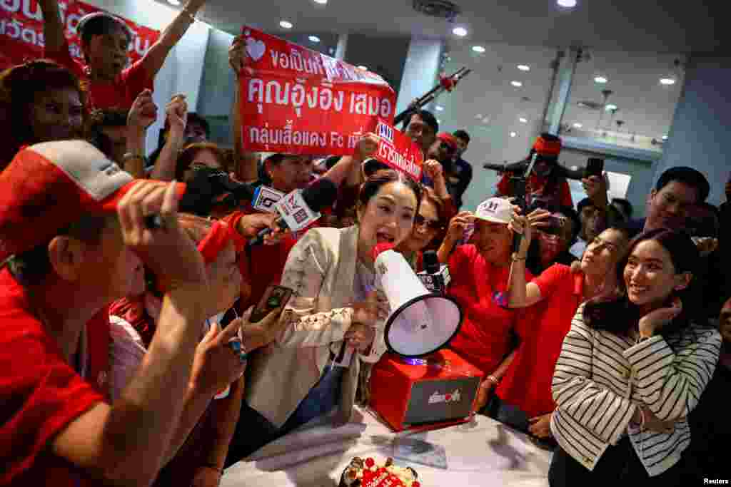 Pheu Thai's prime ministerial candidate, Paetongtarn Shinawatra, attends a birthday celebration held by red shirt supporters, a day ahead of her father, former Prime Minister Thaksin Shinawatra, coming home from self-exile, at the party headquarters in Bangkok, Thailand.