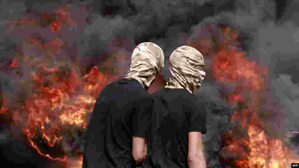 Palestinians burn tires amid clashes with Israeli security forces during the funeral of 19-year-old Labib Damidi in the occupied West Bank town of Huwara.