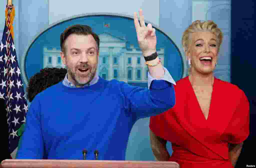Hannah Waddingham reacts as Jason Sudeikis takes questions while the cast of Ted Lasso joined Press Secretary Karine Jean-Pierre at the daily press briefing to discuss the importance of addressing mental health to promote overall well-being, in the Brady Press Briefing Room at the White House in Washington, March 20, 2023. 