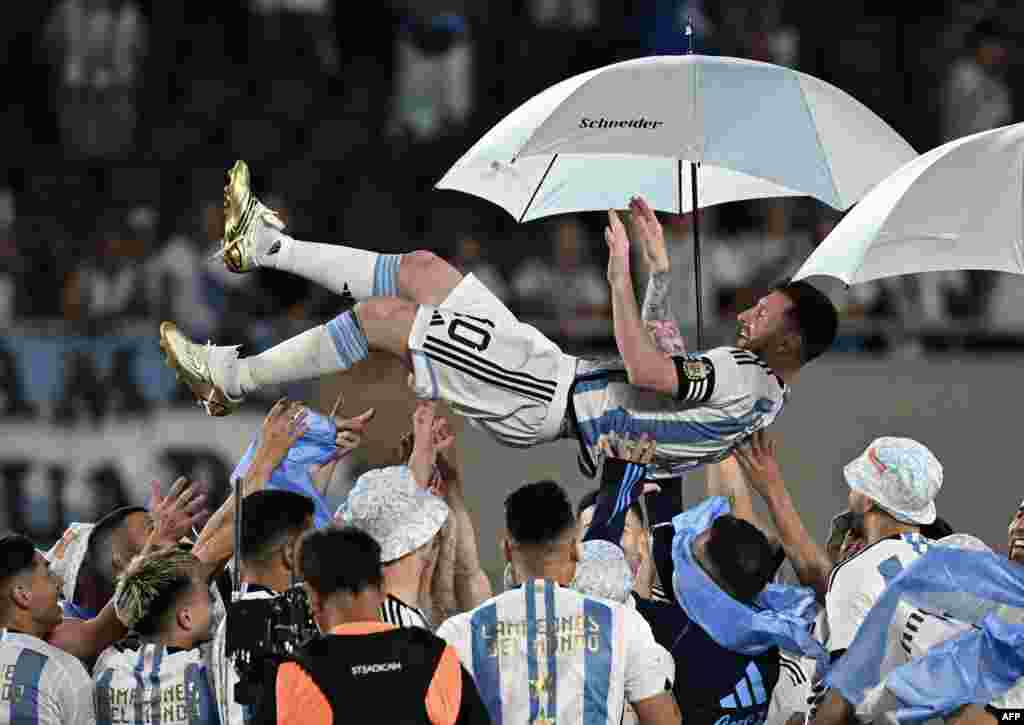 Argentina's forward Lionel Messi is lifted up by teammates during a recognition ceremony for the World Cup winning players, following the friendly football match between Argentina and Panama at the Monumental stadium in Buenos Aires, where Messi scored the 800th goal of his career, on March 23, 2023.