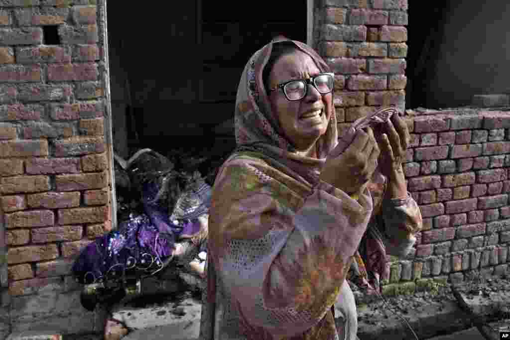 A Christian woman weeps after looking at her home vandalized by an angry Muslim mob in Jaranwala in the Faisalabad district, Pakistan. Police have arrested 129 Muslims after a mob angered over an alleged desecration of a Quran by two men attacked more than a dozen churches and homes of minority Christians.