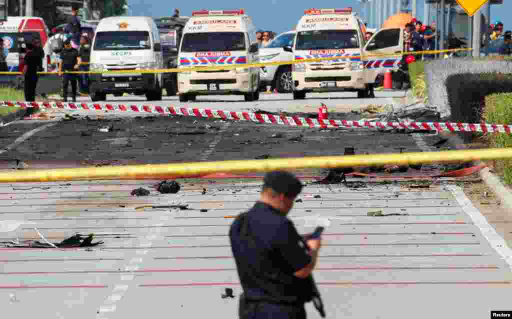 A general view of a plane crash scene in Shah Alam, Malaysia. A small private jet crashed into a motorbike and a car while attempting to land at an airport along the outskirts of the capital Kuala Lumpur, leaving at least 10 people dead, officials said.