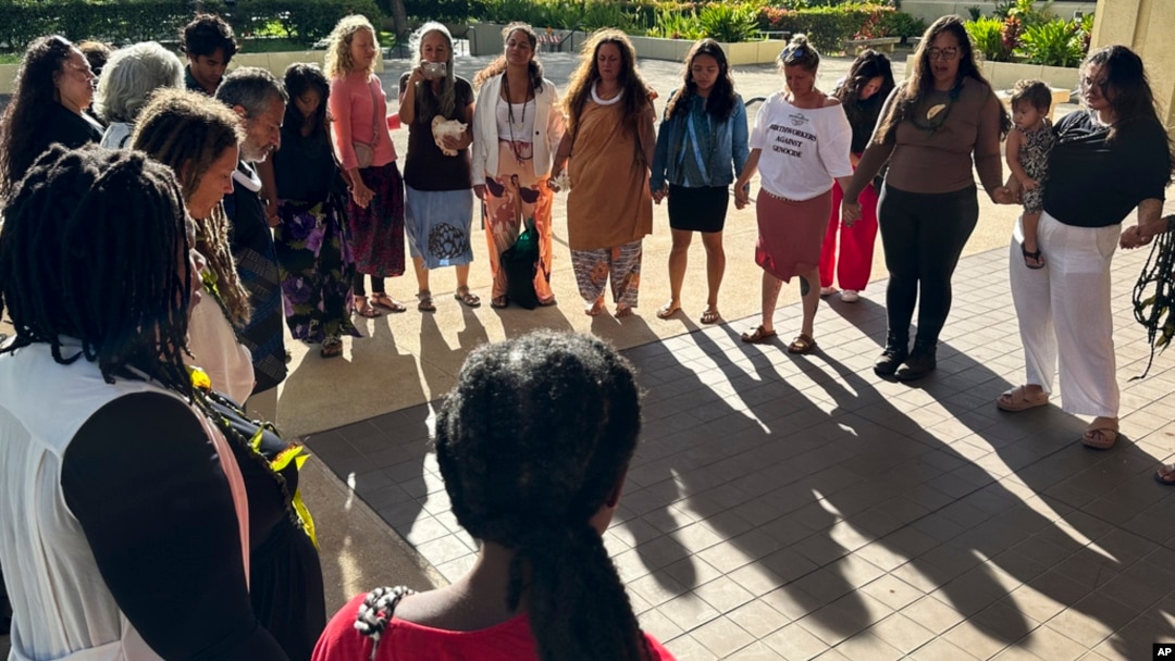 FILE - Supporters of a lawsuit challenging a Hawaii midwife licensure law gather outside a courthouse in Honolulu, June 10, 2024.