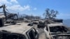 In this photo provided by Tiffany Kidder Winn, burned-out cars sit after a wildfire raged through Lahaina, Hawaii, on Aug. 9, 2023. 