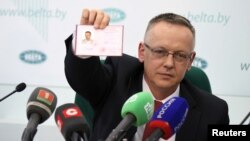 Tomasz Szmydt, a Polish judge who requested political asylum in Belarus, shows his ID document during a press conference in Minsk, Belarus, May 6, 2024. (BelTA/Maxim Guchek/Handout via Reuters)