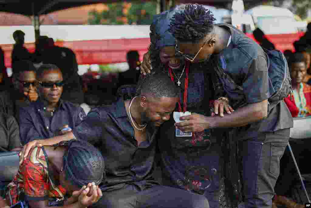 Relatives of Ghana soccer player Christian Atsu weep during his funeral at the State House in Accra, Ghana. Atsu, who played for Premier League teams Chelsea and Newcastle, before joining Turkish club Hatayspor last year, was found dead in his collapsed apartment building in the Turkey earthquake.