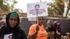 Anti-female genital mutilation (FGM) protesters demonstrate outside the National Assembly in Banjul, Gambia, March 18, 2024, as lawmakers debate a bill seeking to lift the ban on FGM. Lawmakers voted to advance the measure to the next parliamentary stage.
