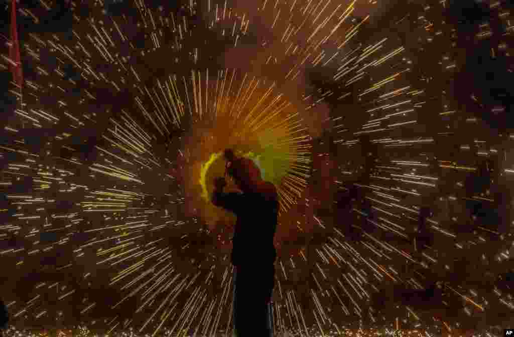 A man lights firecrackers during Dussehra festival in Srinagar, Indian-controlled Kashmir.