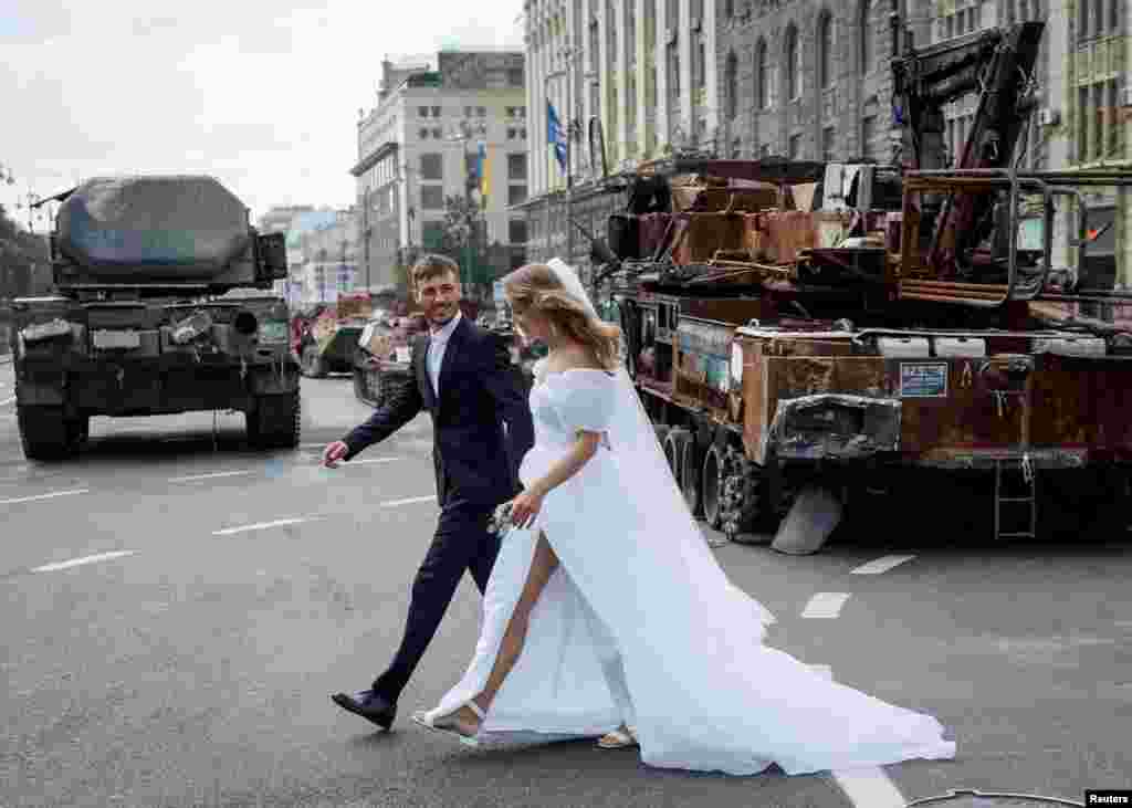 Newlyweds visit an exhibition displaying destroyed Russian military vehicles located on the main street Khreshchatyk as part of the upcoming celebration of the Independence Day of Ukraine, amid Russia's invasion, in central Kyiv, Ukraine.