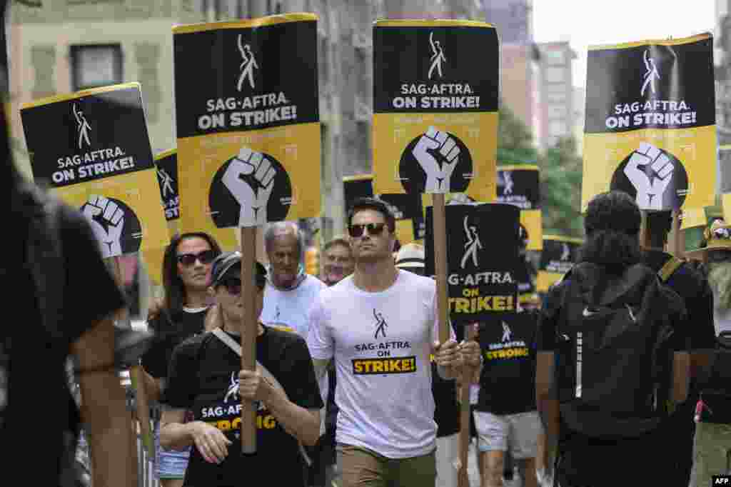 Italia Ricci and Robbie Amell join SAG-AFTRA members on the picket line outside of Warner Bros. Discovery in New York. WGA members marked the 100th day of their industry-crippling strike, dubbing the occasion a "milestone of shame" for studios as the two sides remain deadlocked. 