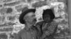This 1917 photo shows John A. Keirn and an unidentified Hopi child standing outside of the Moencopi Day School on the Hopi Reservation in Arizona. Courtesy of USU Special Collections, Merrill-Cazier Library.